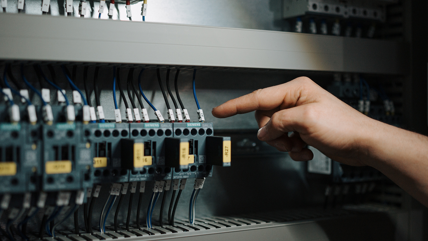 Finger zeigt auf Detail bei Maschine